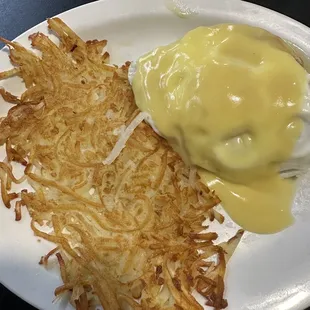 a plate of hash browns and cheese