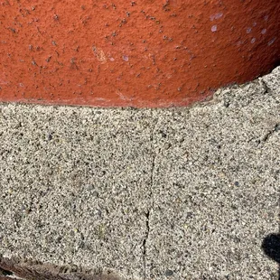 the shadow of a person on a sidewalk