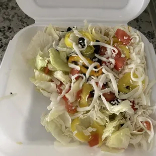 a salad in a styrofoam container