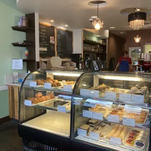 Front display of croissants, pastries, and desserts