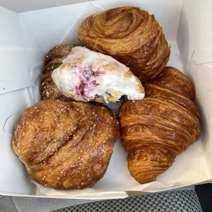 Raspberry Scone, Chocolate Hazelnut Bearclaw, Chocolate Croissant, Lemon Cruffin, and Original Croissant.