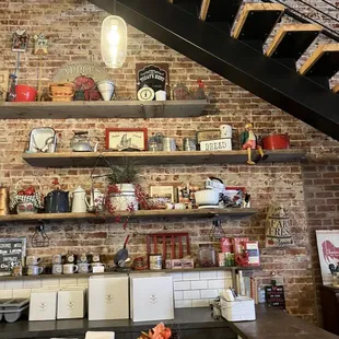a brick wall with shelves and a staircase