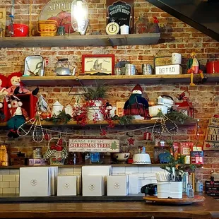 a brick wall and shelves with christmas decorations