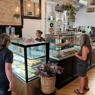 a group of people in a bakery