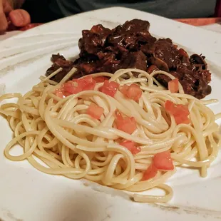 Beef in a wine sauce with a side of pasta