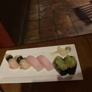 Sea Bass, Yellow Tail, and spicy salmon and wasabi tobiko nigiri.