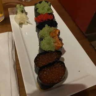 Row Boat nigiri, spicy salmon with wasabi tobiko nigiri, and salmon roe nigiri.