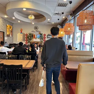 a man walking through a crowded restaurant