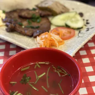 a bowl of soup and a plate of meat