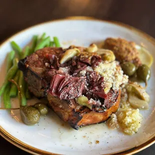 a plate of food with meat and vegetables