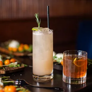 a cocktail with a rosemary garnish garnish