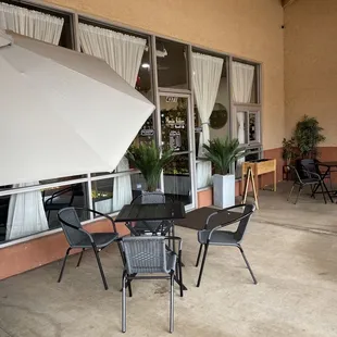 a patio with tables and chairs