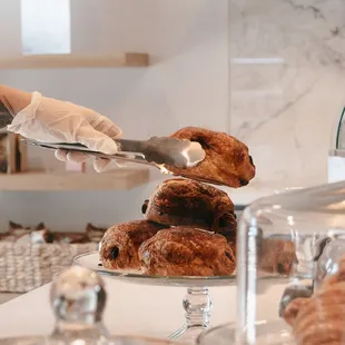 a person serving pastries to a customer