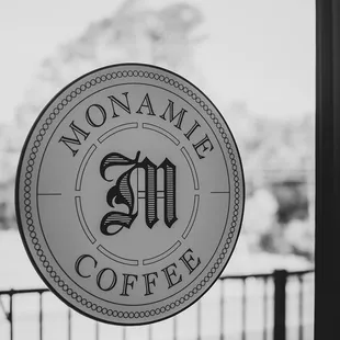 a black and white photo of a cafe sign