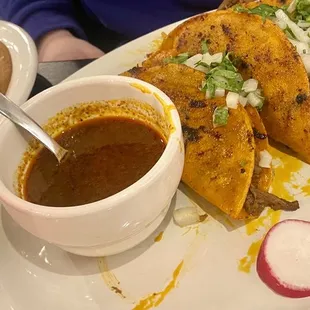 Birria tacos served with consommé. Delicious