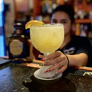 a woman holding a margarita