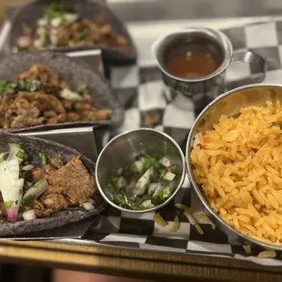 a tray of tacos and rice