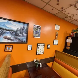 a dining area with orange walls