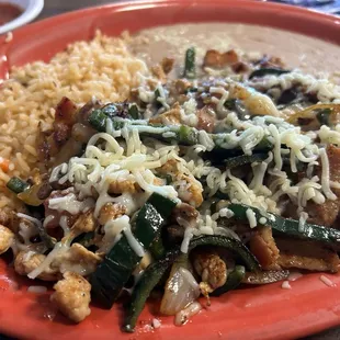 ALAMBRE $12.99 Chopped Steak, Chicken, Bacon, Poblano Peppers, Onions, and Cheese. Served with Rice and Beans