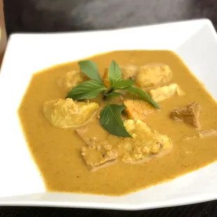 Mama's Yellow Curry, made from scratch available with chicken or Vegan option (Tofu) slow cooked with Japanese Yams, Taro and pumpkin.