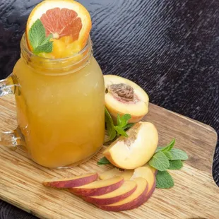 Peach Iced Tea, fresh brewed black tea sweetened with fresh squeezed oranges and chunks of peaches.