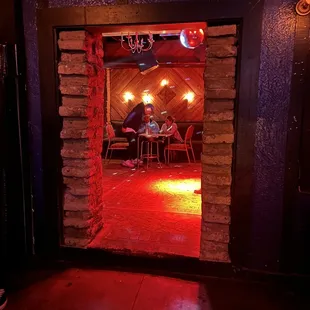 a man sitting at a table in a dimly lit room