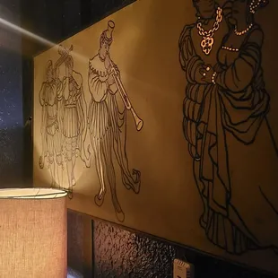 a lamp and a painting on a wall