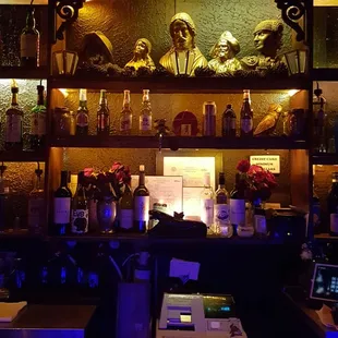 a dimly lit bar with shelves of liquor