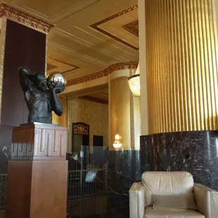 a statue of a man holding a cup