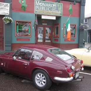 Exterior view with Triumph GT6 of the Monarch Public House during the Walleye 1000 Vintage Rally, June 2013.