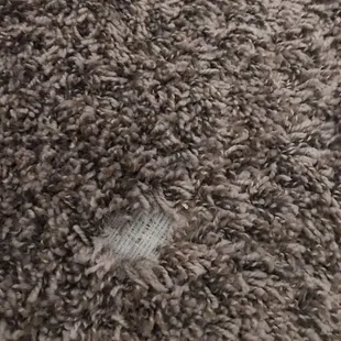 Bare frayed area in carpet