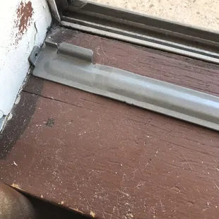 Dirty windowsill with cat hair present peeling paint also