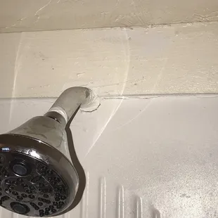 Cracks around showerhead uneven and peeling paint