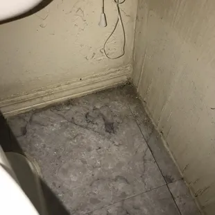 To the right of the toilet dirt/build up