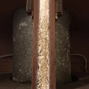 Above the stove...where two cabinets open the  middle wooden piece was sticky and disgusting with build up