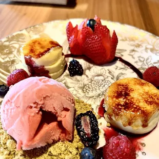 Vanilla Crème Brulee with Pistachio Crumble, Berry Medley, and Strawberry Ice Cream