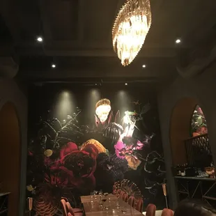 a dining room with a large mural on the wall