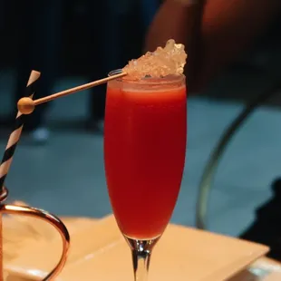 a cocktail in a glass with a straw