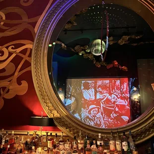 a bar with a mirror and liquor bottles
