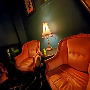 a pair of orange chairs in a dark room