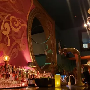 The bar, with this beautiful wall art, and performer space as mentioned in the review blurb. I love the lighting!