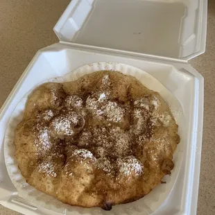 a pastry in a styrofoam container