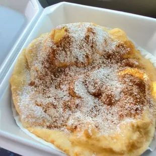 a pancake in a styrofoam container