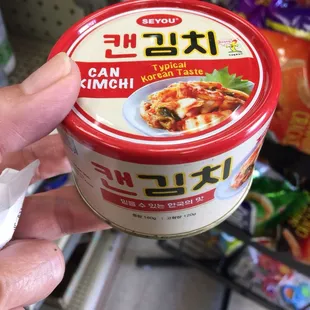 a person holding a can of food