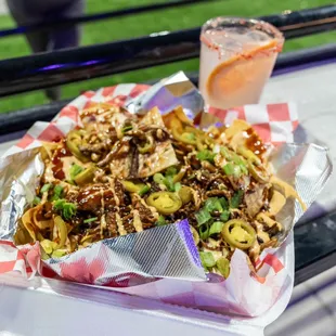 a plate of nachos and a drink