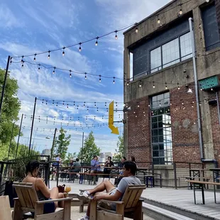 two people sitting on lawn chairs