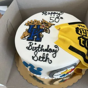 a cake decorated with a university of michigan mascot