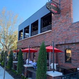 View of Patio and upstairs bar with opened garage door windows