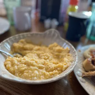 a bowl of grits and a plate of food