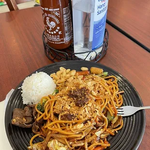 a plate of noodles with meat and vegetables